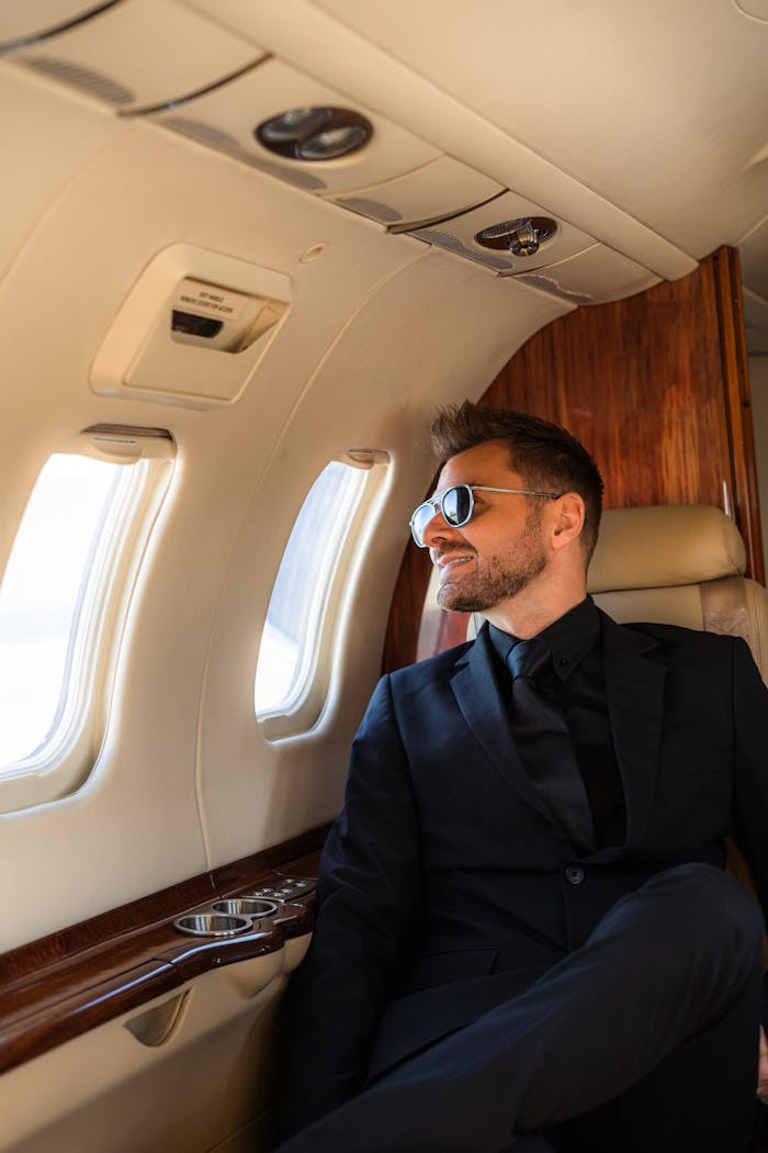 Relaxed businessman in a private jet enjoying a luxurious travel experience.